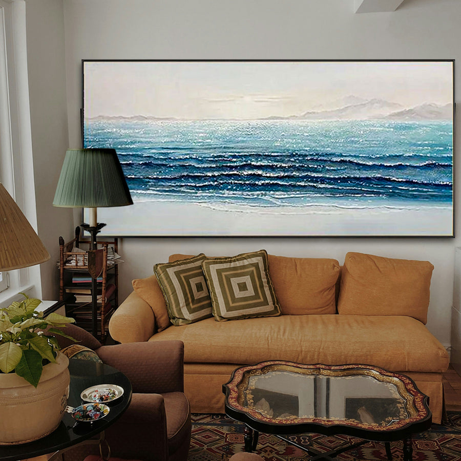 Living room with a large ocean painting above an orange sofa.