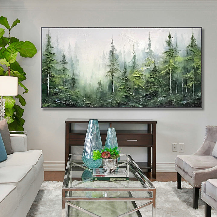 Living room with a forest painting on the wall, glass coffee table, and decorative items.