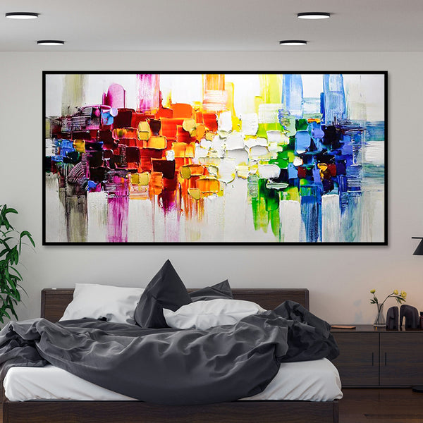 Colorful abstract painting on a wall above a bed in a bedroom.