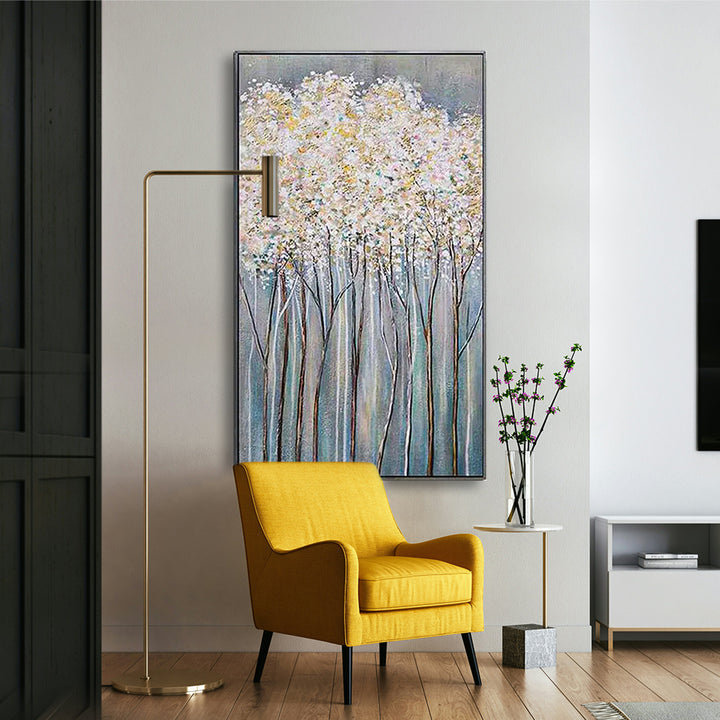 Yellow armchair in a modern living room with a large abstract painting on the wall.