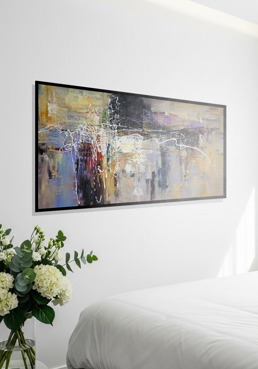 Abstract painting on a wall above a bed with flowers in the foreground