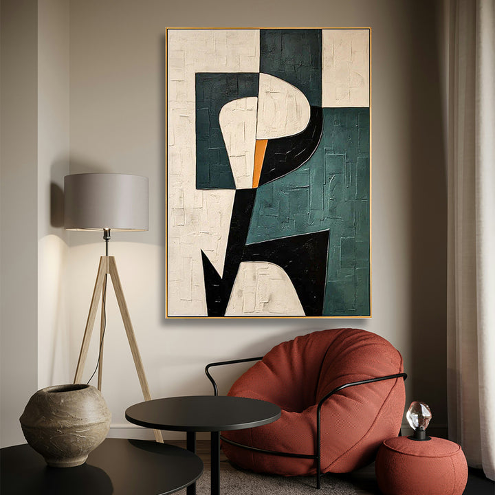 Abstract art piece on a wall in a modern living room with a red chair and lamp.
