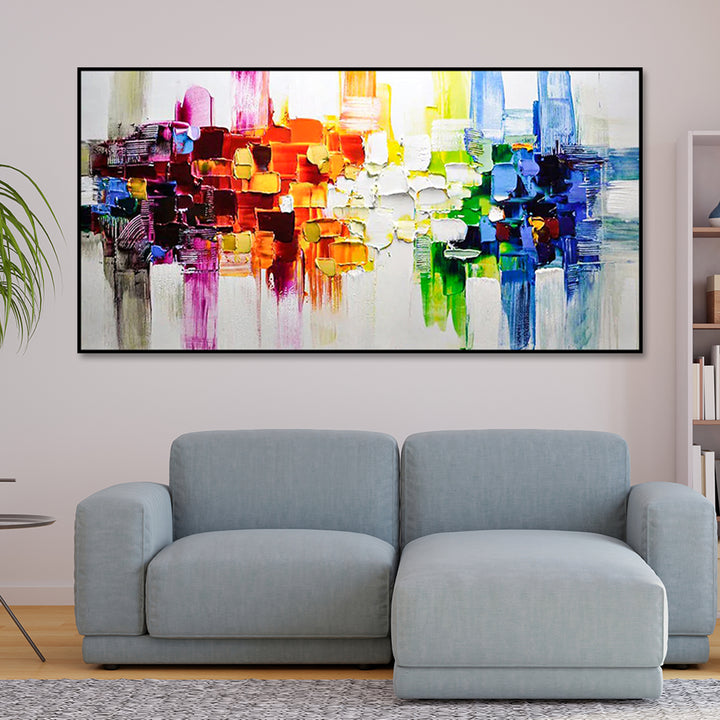Gray sofa in a living room with a colorful abstract painting on the wall.