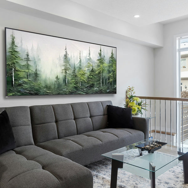 Living room with a gray sectional sofa, glass coffee table, and large forest painting on the wall.