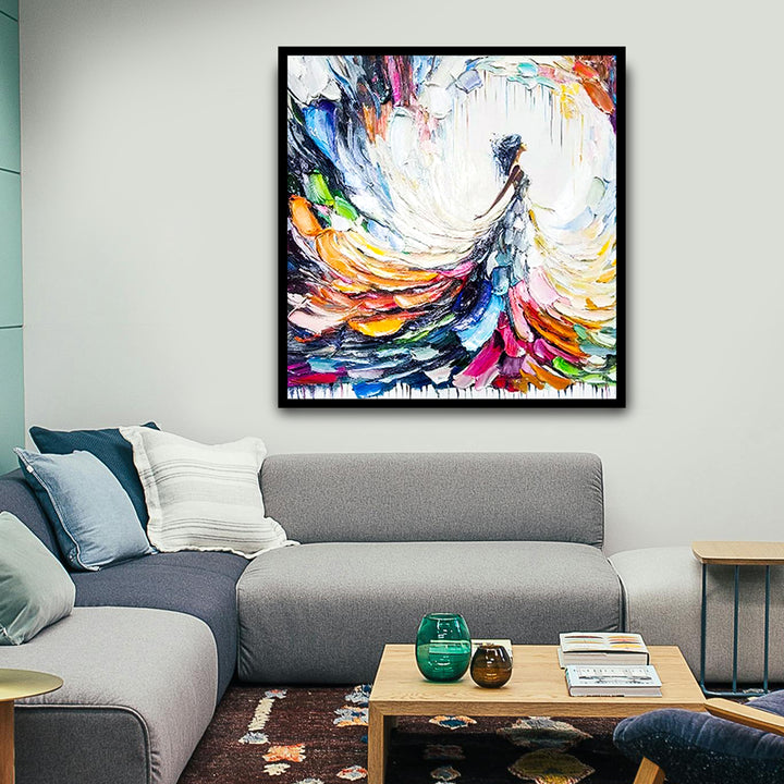 Colorful abstract painting on a wall above a gray sofa in a living room.