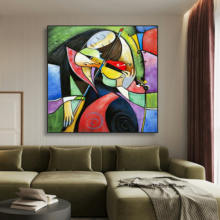 Abstract painting on a wall above a green sofa in a living room.