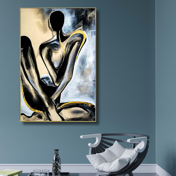 Abstract art piece of two figures on a blue wall above a modern chair.