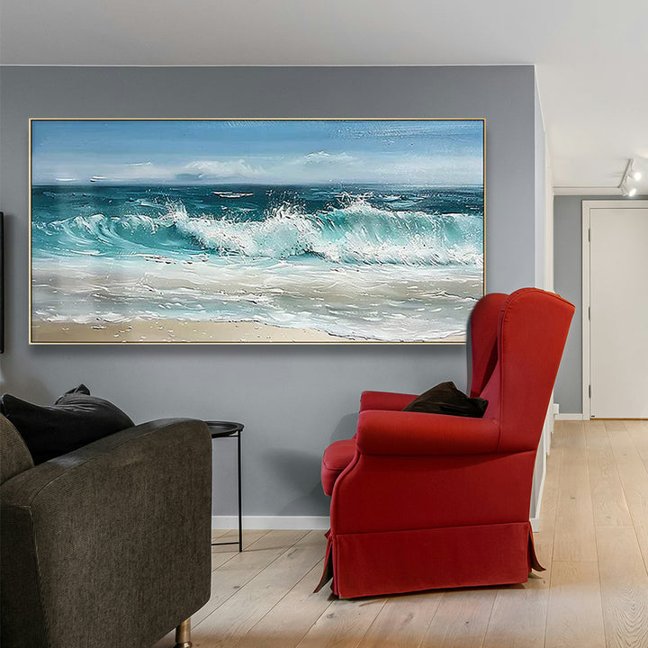 Living room with a red armchair, gray sofa, and large wall art of ocean wave.