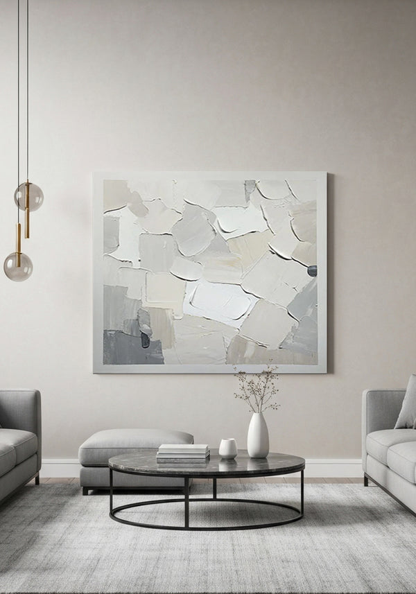 Modern living room with abstract art on the wall, gray sofa, and round coffee table.