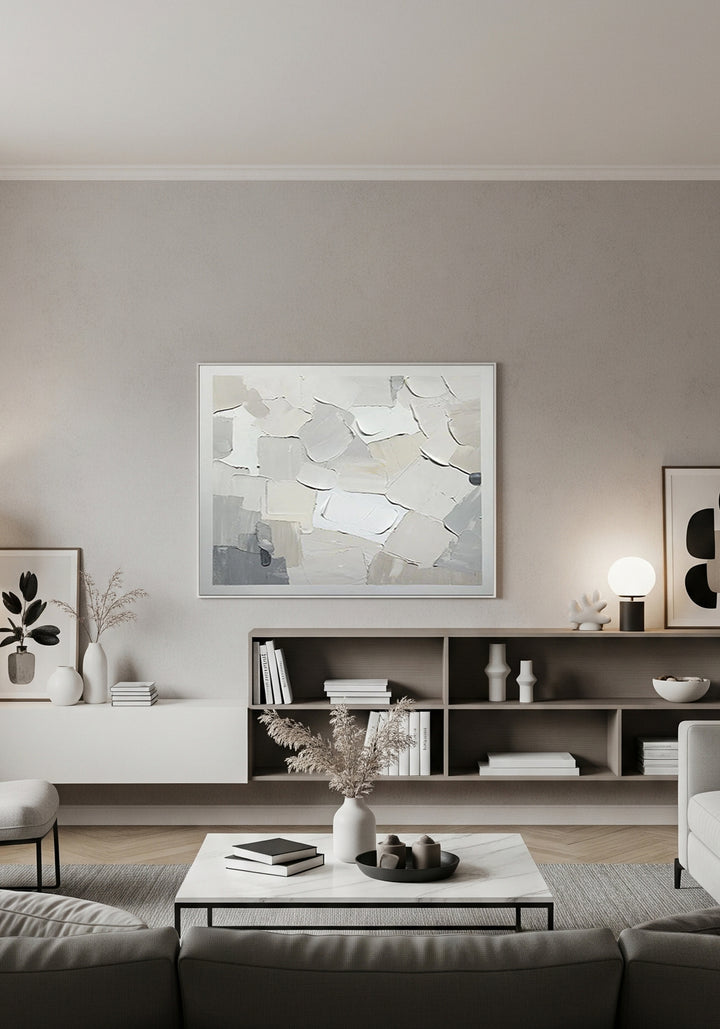 Modern living room with abstract art on the wall and a coffee table with decor items.