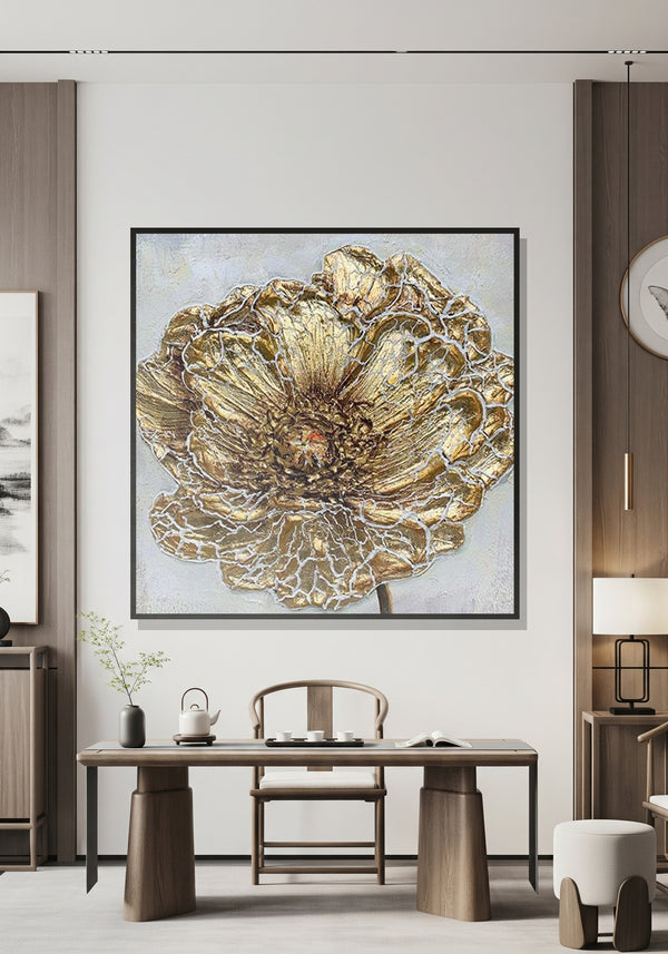 Decorative wall art of a gold floral design in a modern interior setting.