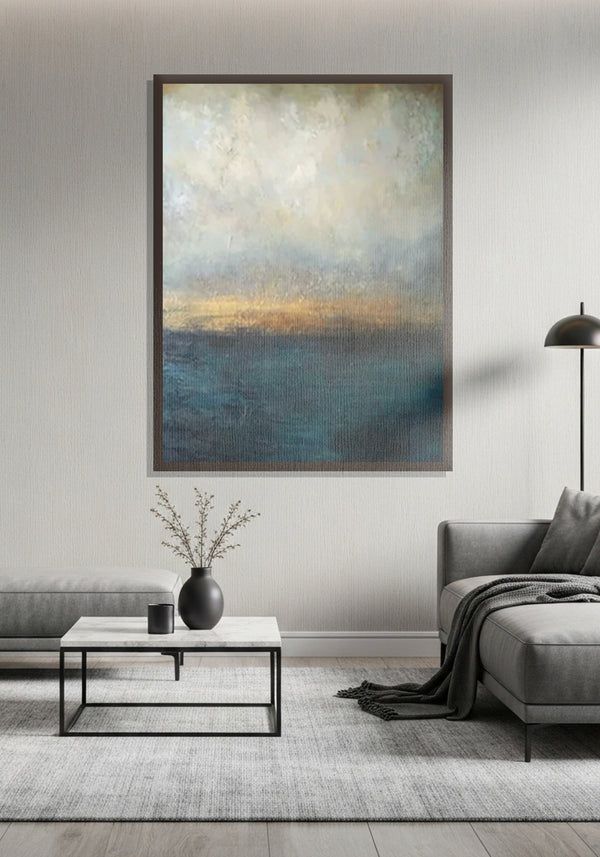 Living room with abstract art on the wall, coffee table, and gray sofa.